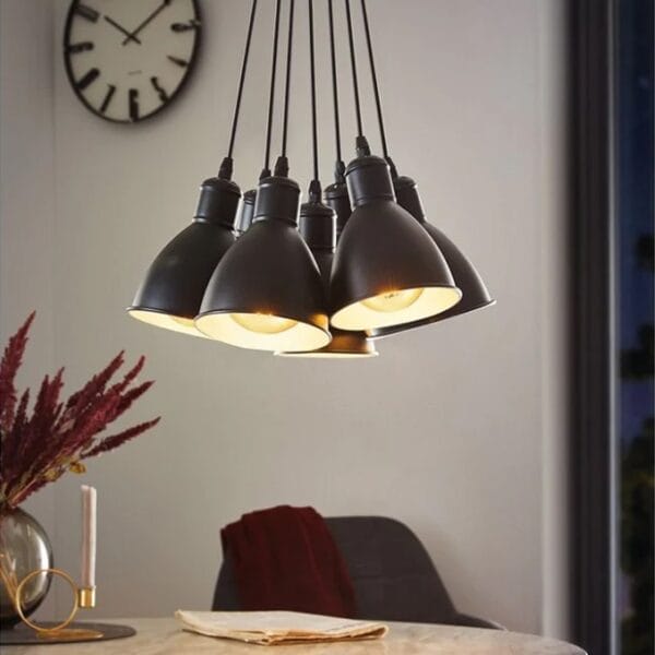 The industrial-style steel Priddy 7 light cluster pendant shade has a white interior to reflect a cleaner glow of light from within. Hang in your stairwell, bedroom, kitchen or dining room for practical yet contemporary lighting.