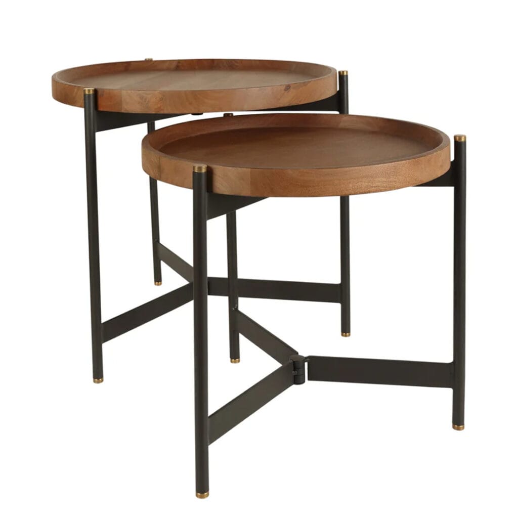 The Roundhouse table features a round top made of mango wood, powder-coated steel legs and solid brass finials. Its foldable legs offer ease of use, and the juxtaposition of wood and metal adds to its slick design. Roundhouse tables are available as both a coffee table and a more compact side table set, allowing you to combine them for a sense of cohesiveness or select them to meet your space requirements.