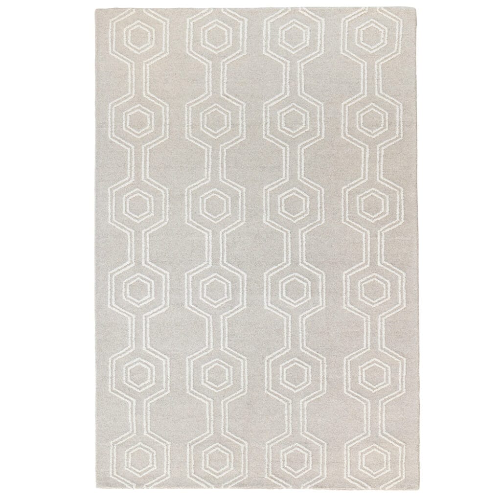 Handwoven in India this wool rug features a loop pile with a hexagon pattern and a durable cotton backing, offering a refined, texture finish. Earthy tones and subtle gradients mimic the colours and contours of mountainous landscapes, creating a grounding atmosphere in any room.