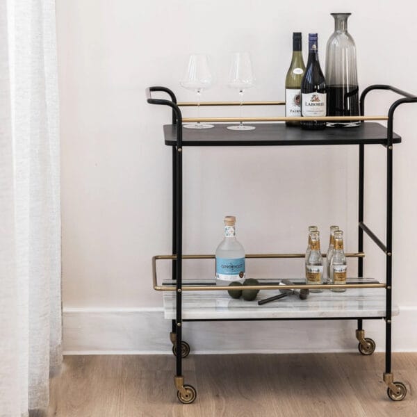 Cheers to our Sable drink trolley, the ultimate party companion that is sure to elevate your hosting game. Composed of marble, mango wood and steel, this versatile piece is perfect for showcasing your favourite drinks and glassware. A must-have for any home bar or entertainment area. Minor assembly required.