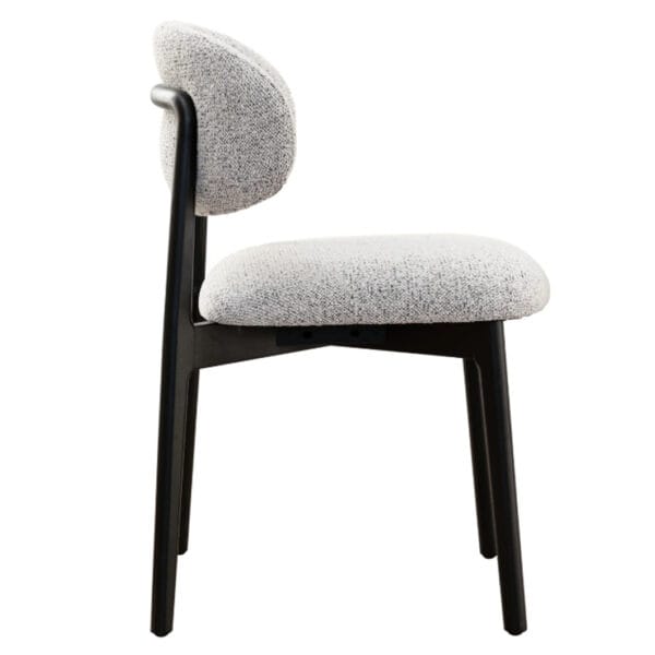 The clean, architectural lines of the Milano solid oak dining chair is a nod to modern design. Upholstered in luxurious 100% Polyester fabric and featuring a robust oak frame, this chair exudes both strength and sophistication. Whether placed at a dining table or in a reading nook, the Milano bridges the gap between contemporary and classic style. Ergonomically curved backrest. Available in two colourways.