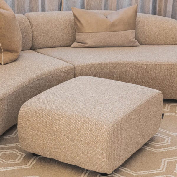 The beautifully upholstered Echo ottoman features a sturdy wooden frame and versatile shades. Covered with 100% polyester Pascal fabric, it's ideal for adding a touch of sophistication and functionality to a home,